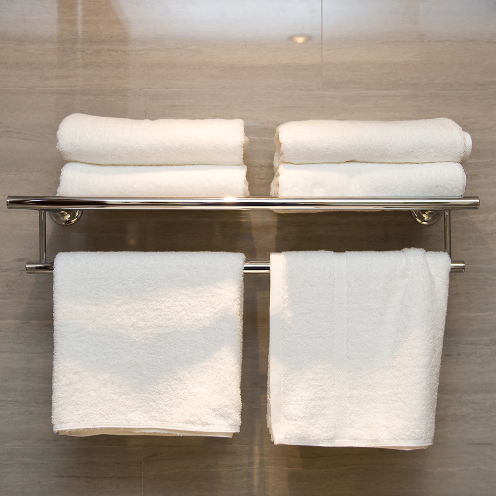 stylish towel rack with bars holding white towels