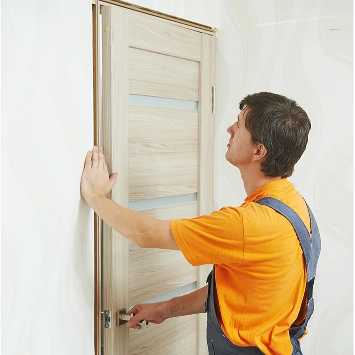 man installing door